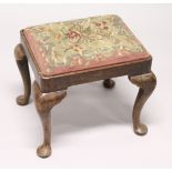 A GEORGIAN STOOL with needlework top on cabriole legs 1ft 7ins wide.