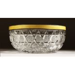 A CUT GLASS CIRCULAR BOWL with silver and yellow enamel rim 6ins diameter