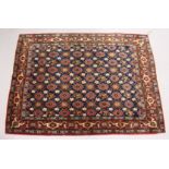 A GOOD PERSIAN WERAMIN SMALL CARPET, with rich blue ground with all over floral pelmet and design.
