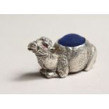 A NOVELTY SILVER CAMEL PIN CUSHION.