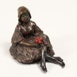 A BRONZE SEATED EROTIC GIRL