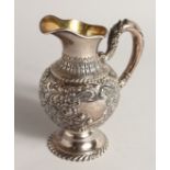 A VICTORIAN SILVER JUG with repousse decoration 6.5ins high