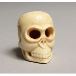 A CARVED BONE SKULL