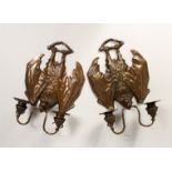 AN UNUSUAL PAIR OF CAST BRONZE BAT SHAPED TWIN LIGHT WALL SCONSES.