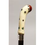 AN EDWARDIAN IVORY HANDLE WALKING CANE with silver band and cabochon stones, F. WEST CARNE, 59