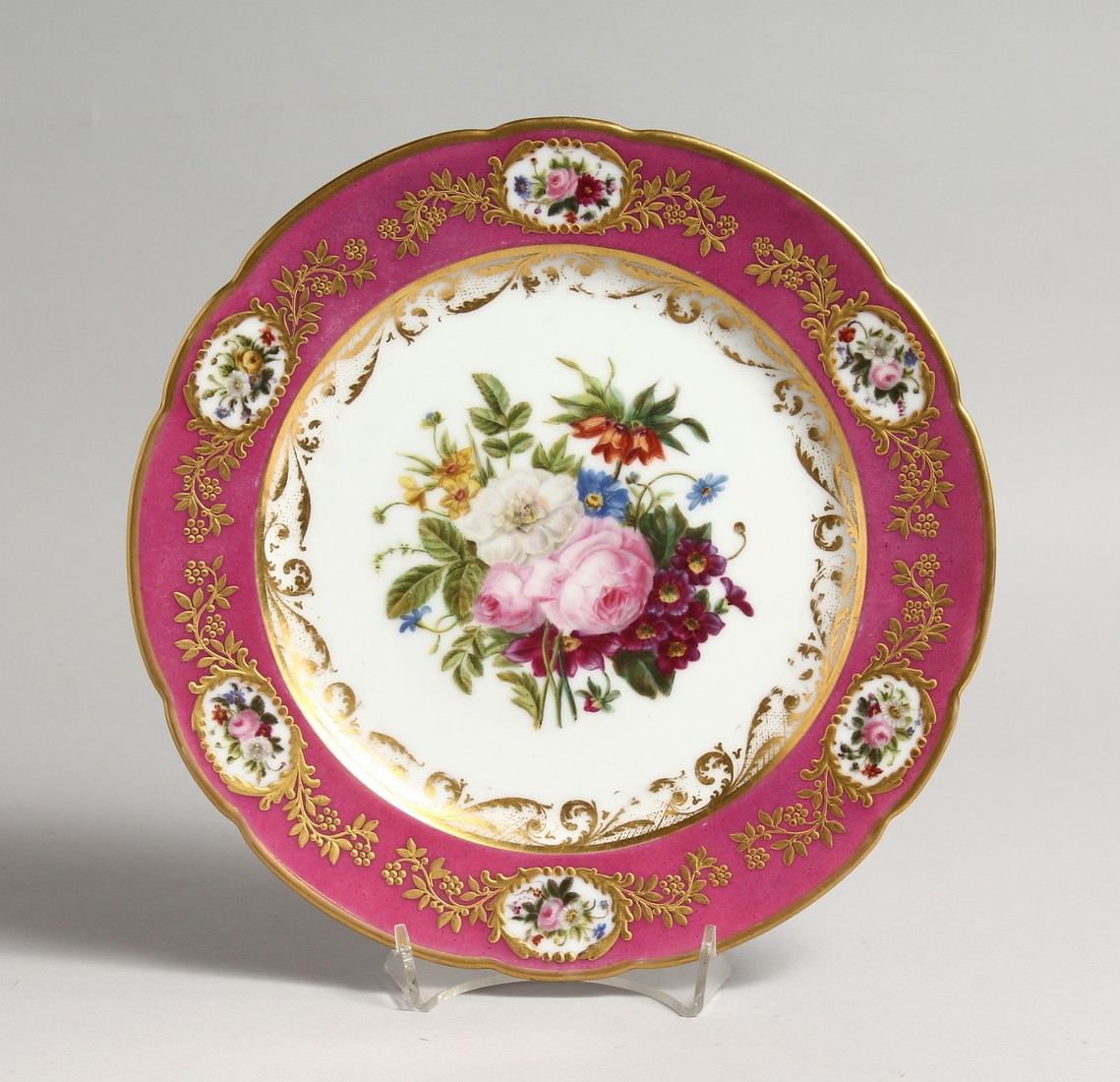 A 19TH CENTURY FRENCH DENVELLE PORCELAIN PLATE with rose coloured border, vignettes of flowers, gilt