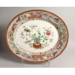 A LARGE OVAL MEAT DISH painted with flowes 20ins long