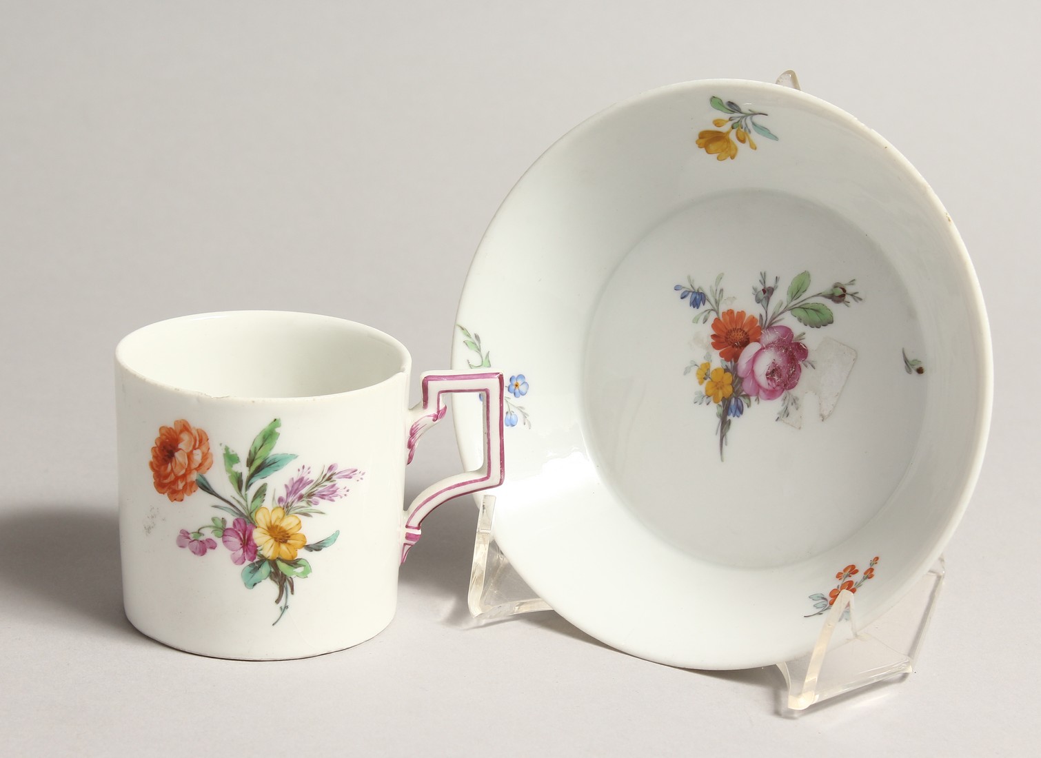 A 19TH CENTURY MEISSEN COFFEE CUP AND SAUCER painted with flowers. Septre mark in blue