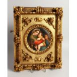 A GOOD GERMAN PORCELAIN CIRCULAR PLAQUE, Madonna and child 5.5ins diameter, in a gilded frame.