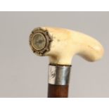 A GOOD 19TH CENTURY WALKING STICK with bone handle inset with a compass and silver band. 31ins long