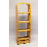 AN ART DECO STYLE BURR WOOD FREE STANDING OPEN BOOKSHELF, with four shelves on a platform base.