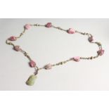 A 19TH CENTURY CHINESE QING DYNASTY CARVED JADE PENDANT NECKLACE with Touraline beads.