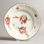 AN 18TH CENTURY CONTINENTAL CIRCULAR DISH painted with flowers 11ins diameter.