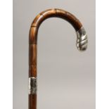 A WALKING STICK with silver handle. London 1929, 35ins long
