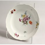 A GOOD 20TH CENTURY MEISSEN CIRCULAR DISH with shaped border and painted with flowers. 11ins
