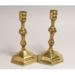 A PAIR OF 18TH CENTURY BRASS CANDLESTICKS on hexagonal bases 7 ins high.