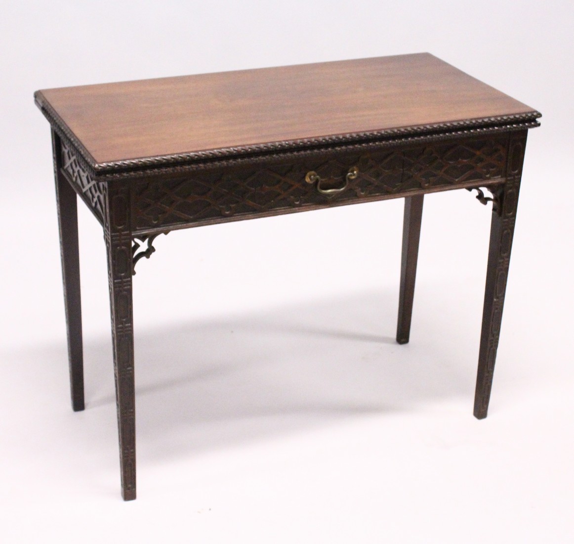 A GOOD GEORGE III MAHOGANY RECTANGULAR FOLDING TOP TEA TABLE with blind fret, curving and single