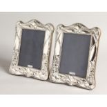 A PAIR OF SILVER ART NOUVEAU STYLE PHOTOGRAPH FRAMES. 8ins x 5.5ins