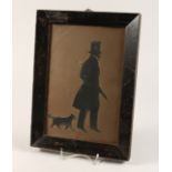 A VICTORIAN FRAMED AND GLAZED SILHOUETTE OF A GENTLEMAN, with his dog. 10ins x6.5ins