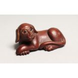 A JAPANESE CARVED WOOD DOG NETSUKE.