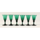 A SET OF SIX GREEN GLASSES 5ins high