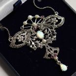 AN ART NOUVEAU STYLE SILVER RUBY AND OPAL PENDANT AND CHAIN.