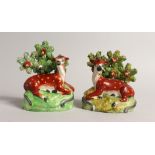 A PAIR OF STAFFORDSHIRE BOCAGE GROUPS OF RED DEER with yellow spots and Bocage backs 4.5ins high.