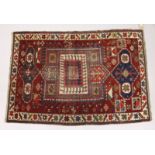 AN UNUSUAL SMALL CAUSASIAN SHIRWAN RUG, claret ground with stylised design. 4ft 2ins x 2ft 10ins