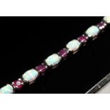 A SILVER RUBY AND OPAL LINE BRACELET