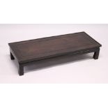 A GOOD CHINESE REDWOOD RECTANGULAR TOP OPIUM TABLE with cross banded top. 3ft 4ins long, 1ft 4ins