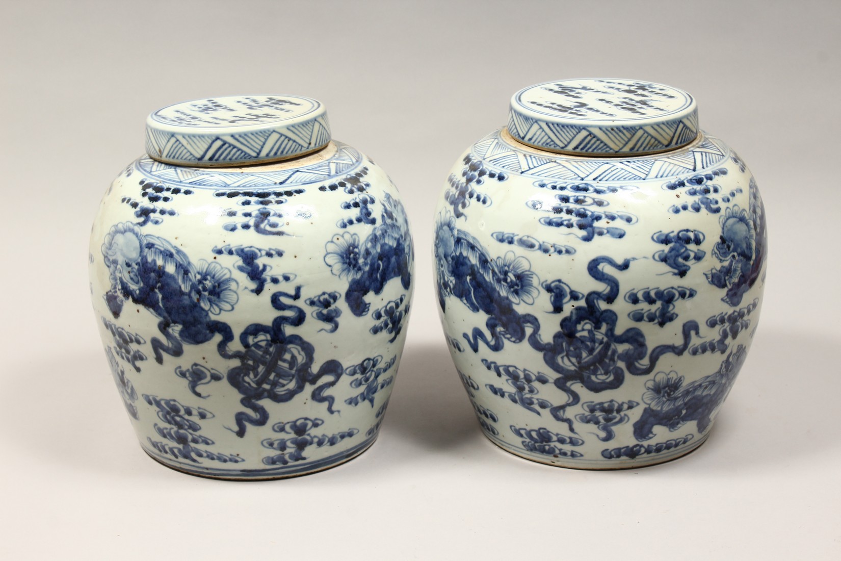 A PAIR OF CHINESE BLUE AND WHITE PORCELAIN JARS AND COVERS, painted with lion dogs 12.5ins high. - Image 4 of 8