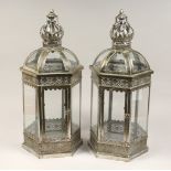 A PAIR OF HEXAGONAL SHAPED SILVER METAL HANGING LANTERNS 25ins high.