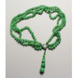 A TRIPLE ROW OF JADE BEADS with opal clasp