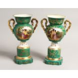 A PAIR OF 19TH CENTURY PARIS GREEN GROUP TWO HANDLED URNS with reverse panels of figures and flowers