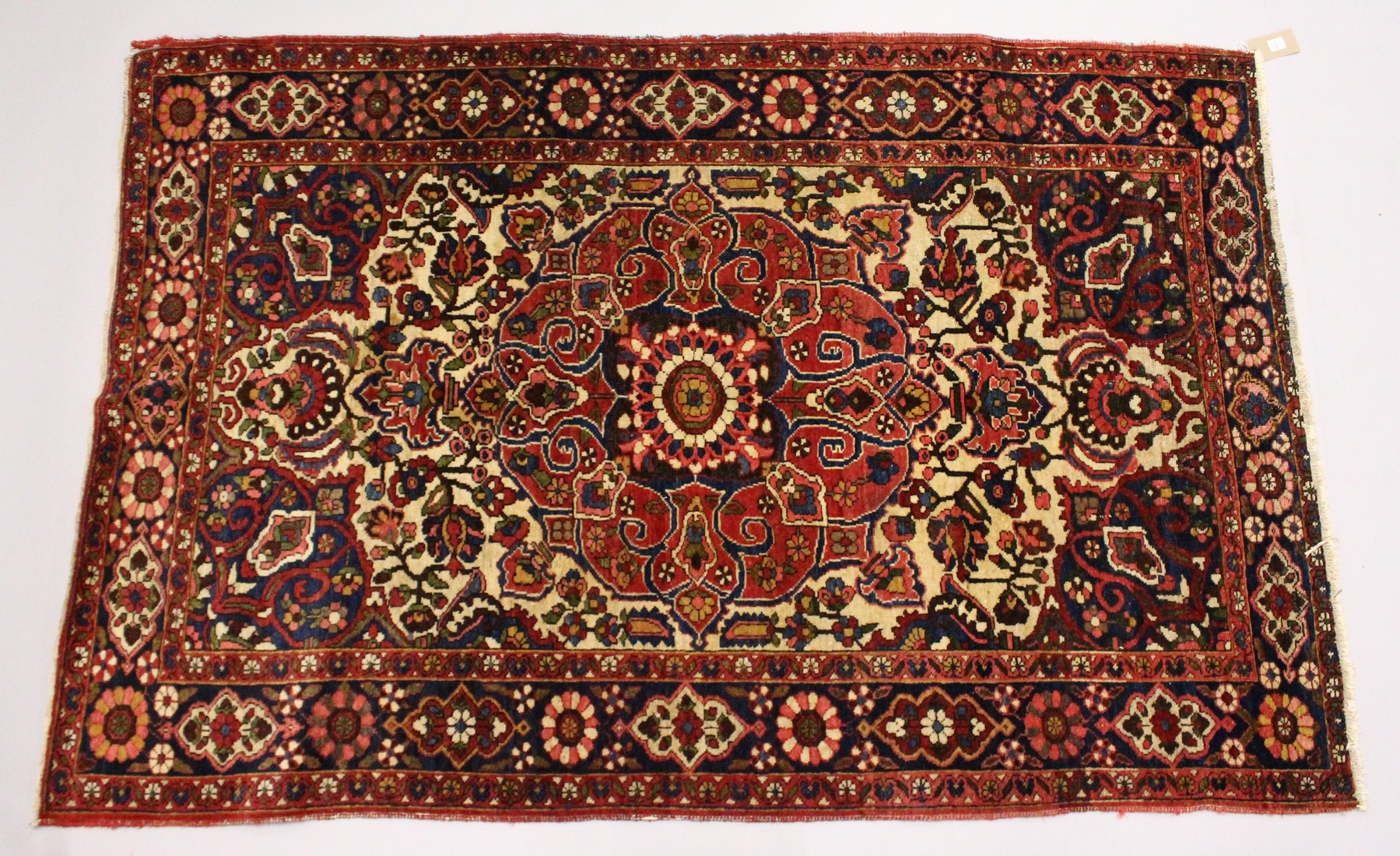 A PERSIAN BAKHTIAR CARPET, cream ground with all over floral design. 6ft 8ins x 4ft 4ins