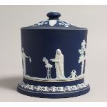 A WEDGWOOD JASPER WARE BLUE AND WHITE BISCUIT BARREL AND COVER