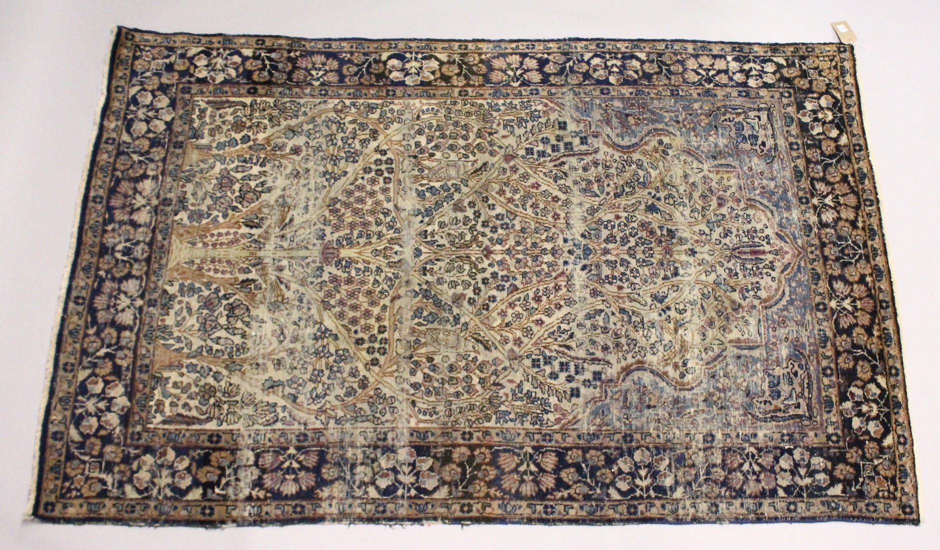 A PERSIAN KERMAN CARPET, cream groud with a stylised tree design. 7ft x 4ft 5ins