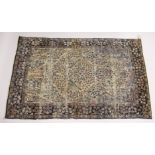 A PERSIAN KERMAN CARPET, cream groud with a stylised tree design. 7ft x 4ft 5ins
