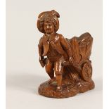 A GOOD SMALL BLACK FOREST CARVED WOOD BOY pulling a cart 5ins