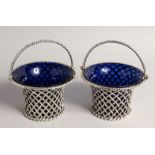 A VERY GOOD PAIR OF VICTORIAN PIERCED CIRCULAR BASKETS with swing handles and sapphire blue liners