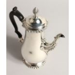 A SILVER COFFEE POT, with reeded finial, gadrooned rim and foot rim. London 1887 14ozs 8.5ins high