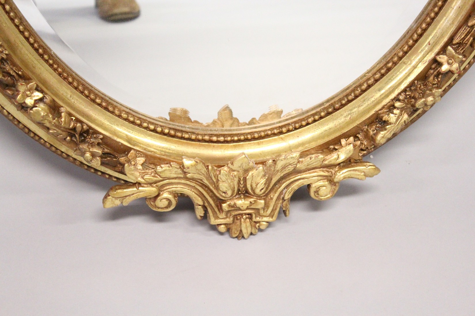 A DECORATIVE GILT FRAMED OVAL WALL MIRROR 3ft 7ins high x 2ft 6ins wide - Image 4 of 5