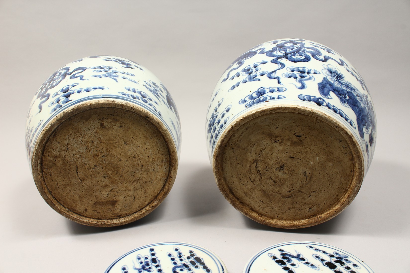 A PAIR OF CHINESE BLUE AND WHITE PORCELAIN JARS AND COVERS, painted with lion dogs 12.5ins high. - Image 7 of 8