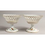 A GOOD PAIR OF 2OTH CENTURY MEISSEN PIERCED PEDESTAL BASKET painted with birds. 8.5ins diameter 7