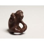 A JAPANESE CARVED WOOD MONKEY NETSUKE