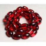 A STRING OF CHERRY AMBER BEADS