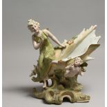 IN THE MANNER OF ROYAL DUX - A SHELL with young lady and cherub on a scrolled stand.