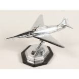 A CHROME AEROPLANE LIGHTER on stand