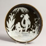 A GOOD PATE SUR PATE CIRCULAR DISH with classical figures in relief, beside a pool. 12ins diameter