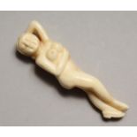 A CARVED BONE DOCTOR'S NUDE 3.5ins long.
